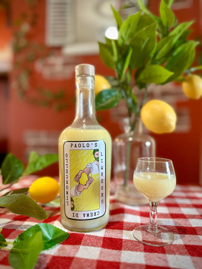 A picture of bottle of crema di limoncello on a chequered table cloth by Paolo's Liqueurs